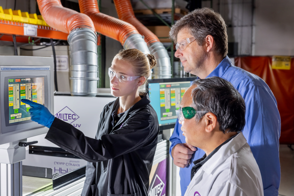 Miltec chemists using a touchscreen to conduct research